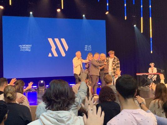 10/2/22: the congregation praying over the new pastor family. Pastor Alan, Heidi & Magnus.