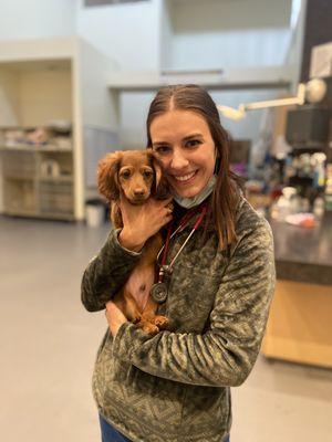 Dr. Walla snuggling with one of her puppy patients!