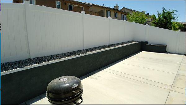 New retaining wall with concrete featuring blue stucco