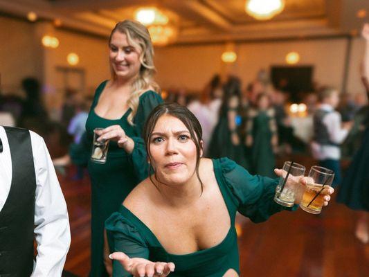 Bridesmaids goofing around on dance floor at wedding reception