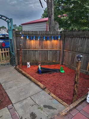 Plastic pond with budlight can lighting with fresh red mulch