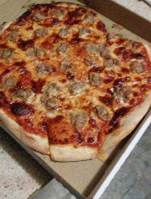 large sausage pizza... with 1 corner slice taken off already because I couldn't wait to eat it