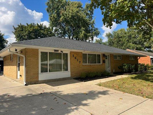 finished roofing project replacing shingles on a brick ranch