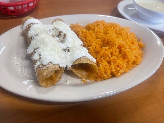 Chicken Flautas with sour cream and cheese with a side of rice! *Ordered a la carte