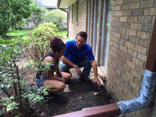 Flowerbed sloping toward the home and causing rainwater to enter the wall.