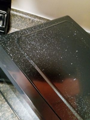 Splatter from oven cleaner on microwave