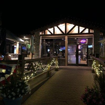 Outdoor seating/front/entrance at night.