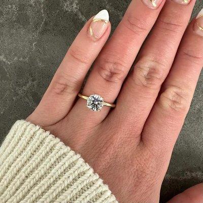 solitaire engagement ring on hand