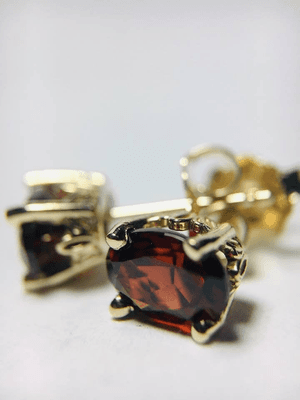 Garnet stud earrings in 14kt yellow gold.