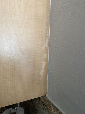 Damaged cabinet from painter. Tape peeled finish