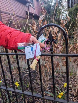 Happy Easter dog bone treats tied to the fence with a note from your dog friends, Olivia and Jilli