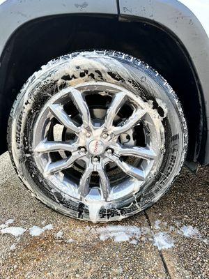 Wheel and tire in the process of being cleaned.