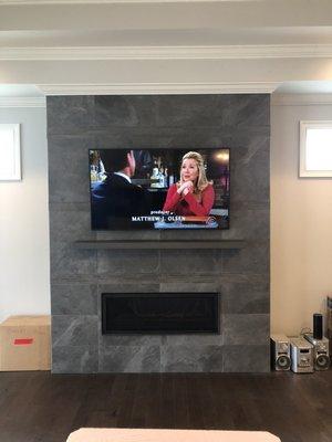 TV mounted over Fireplace on Porcelain Tiled Wall