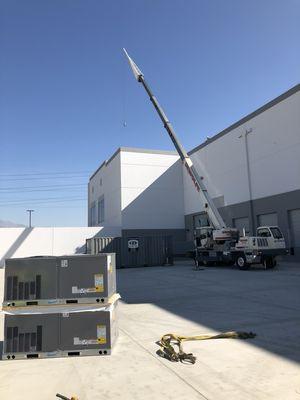 Staging the crane to get the new units up on the roof