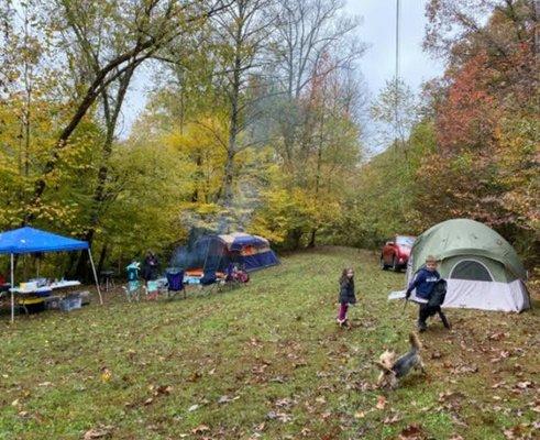 Tent camping under the trees right along the river.