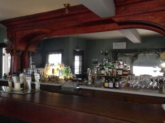 beautiful columned woodwork and mirror behind the bar.