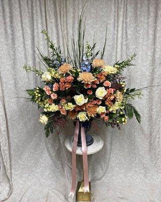 Urn Pedestal Arrangement with Cream, Blush, and Light Blue Florals