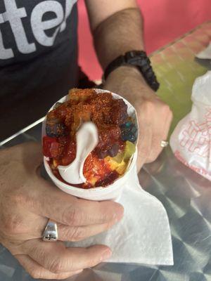 Mangonada with chamoy, tajin, pickles and gummy bears.