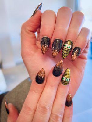 The black and gold glitter with the mummy design is perfect for the season.