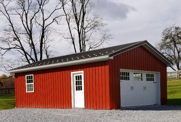 One-car garage built in 2017 in PA. Burnished Slate roof, Red siding, Bright White trim, snow guards, and carriage style doors.