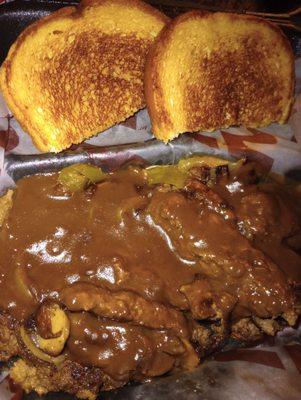 Chopped hamburger steak with onions peppers mushrooms and gravy