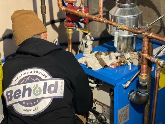 The Behold Team at work on a Boiler replacement project.  Heat was restored and a happy family for the holidays!