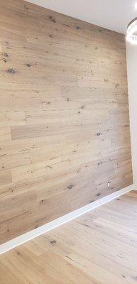 Wood flooring installation on wall.