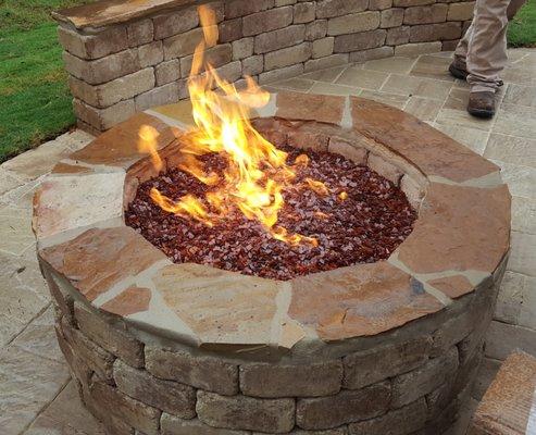 Fire pit, patio, and sitting wall installed by Southern Pride Landscaping.