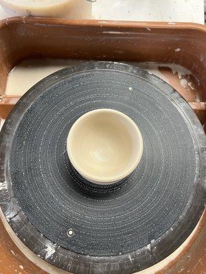 A clay pot on a pottery wheel