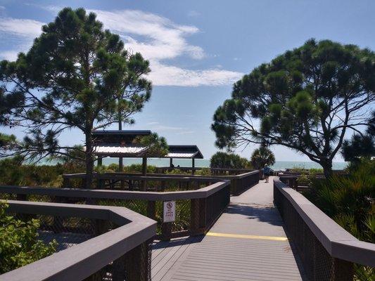 Boardwalk. Covered picnic spots along it.