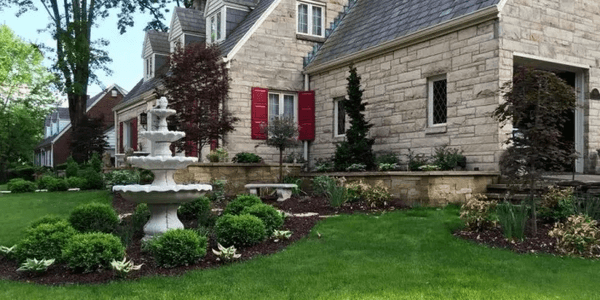 Sandstone wall and cap. Masonry staircase, walkway, and front entry. Lawn, planting, irrigation, and lighting.