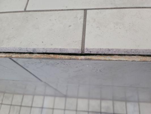 Tile pulling away from shower bench during a shower