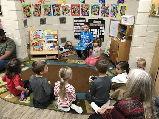 My oldest reading to students during a Family Night.