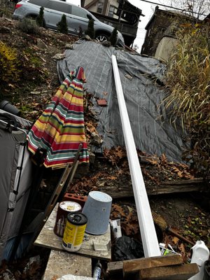 Left downspout on hillside.