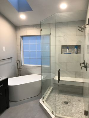 Custom bathroom with new free-standing tub and shower bench.