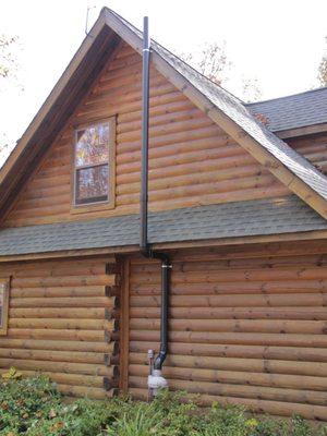 Black ABS pipe on log home.