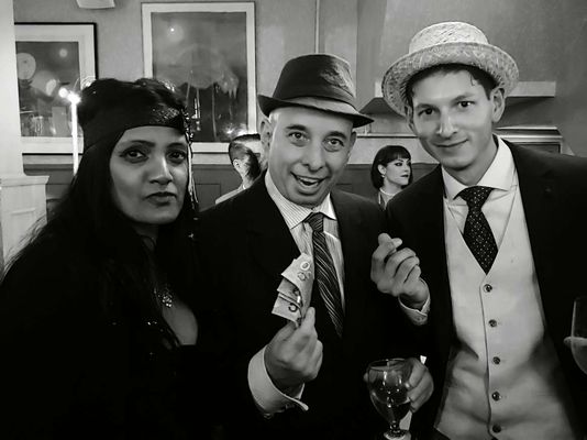 Guests having fun at a 1920s murder mystery