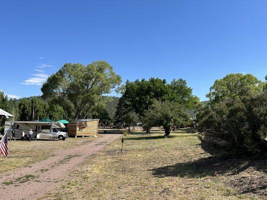 Coming into location, 3 gravel RV pads on left, 5 cabins farther back.