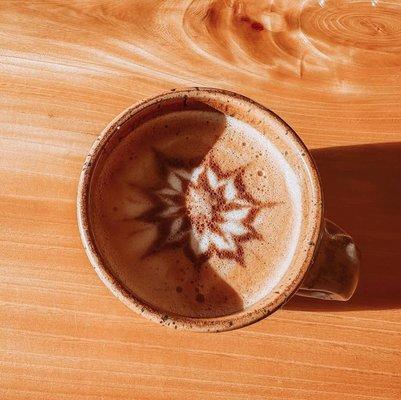 Latte in handmade mug with latte art