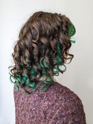 A fresh haircut styled with finger curls.