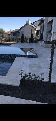 Infinity edge spa with travertine decking