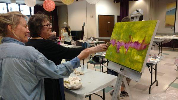 Instructor Virginia Paquette lending some guidance in her class, Spring Painting and Abstraction.