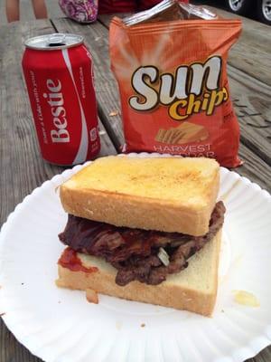 Ribeye steak sandwich , w grilled onions , barbecue sauce on garlic bread !