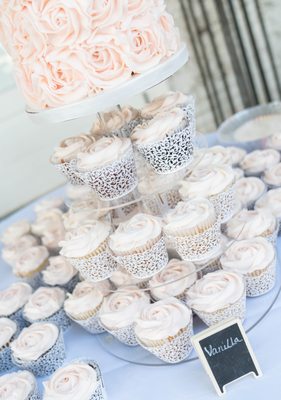 Small wedding cutting cake for couple and cupcake selection for guests.