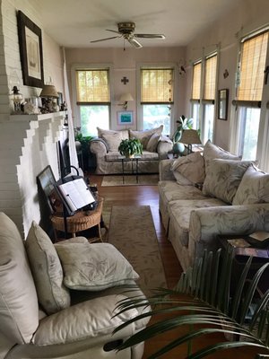 Lovely sunroom with super comfy couches an amazing amount of sun perfect for an afternoon of reading or nothing