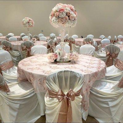 Tablecloths, overlays, chair covers and chair bows for pink and ivory quincenera.