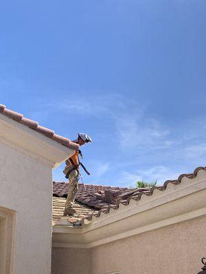 Roofers completing a leak repair.