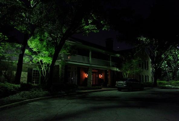 Elegant landscape lighting in the trees and on the grounds of this estate.