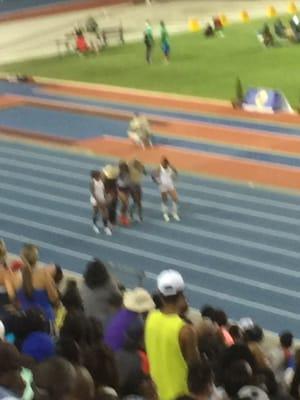 A picture of sportsmanship. The 200m sprinters walking Lauren Rain Williams to the finish line after she cramped on the curve..