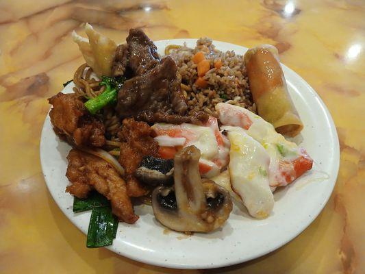 Lo mein, rice, cheesy crab, spring roll, mushrooms, and honey chicken.